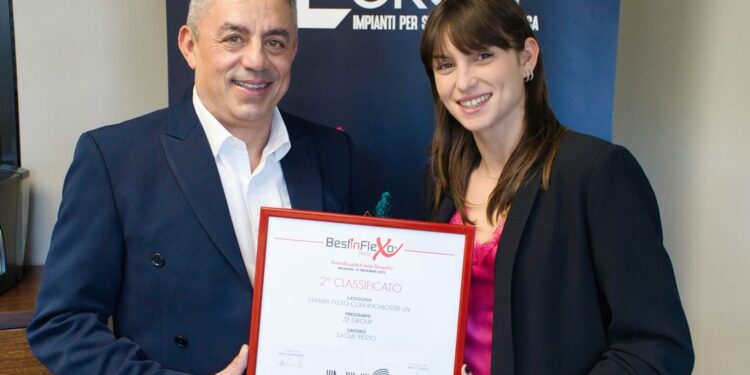 Owner, Sandro Bisoli next to co-owner Noemi Bisoli showing off the ATIF print award.
