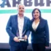 Leandro Goulart, Head of Marketing and Sales Arburg Brazil, accepts the PPR for "TOP Equipment in Electric Drives" for Arburg from Jane Campos, Radici Plastics Ltda.